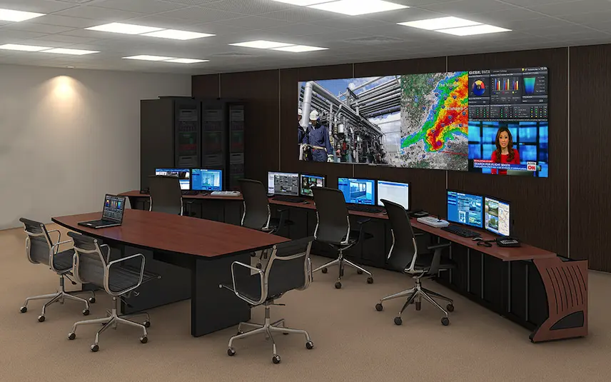 Security control room with multiple surveillance monitors displaying live CCTV footage for 24/7 monitoring.
