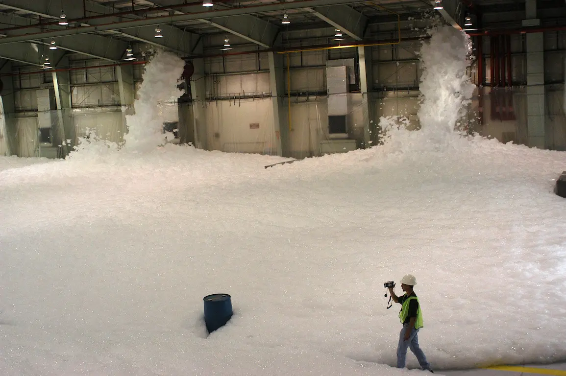Active high expansion foam generators operating in a large warehouse