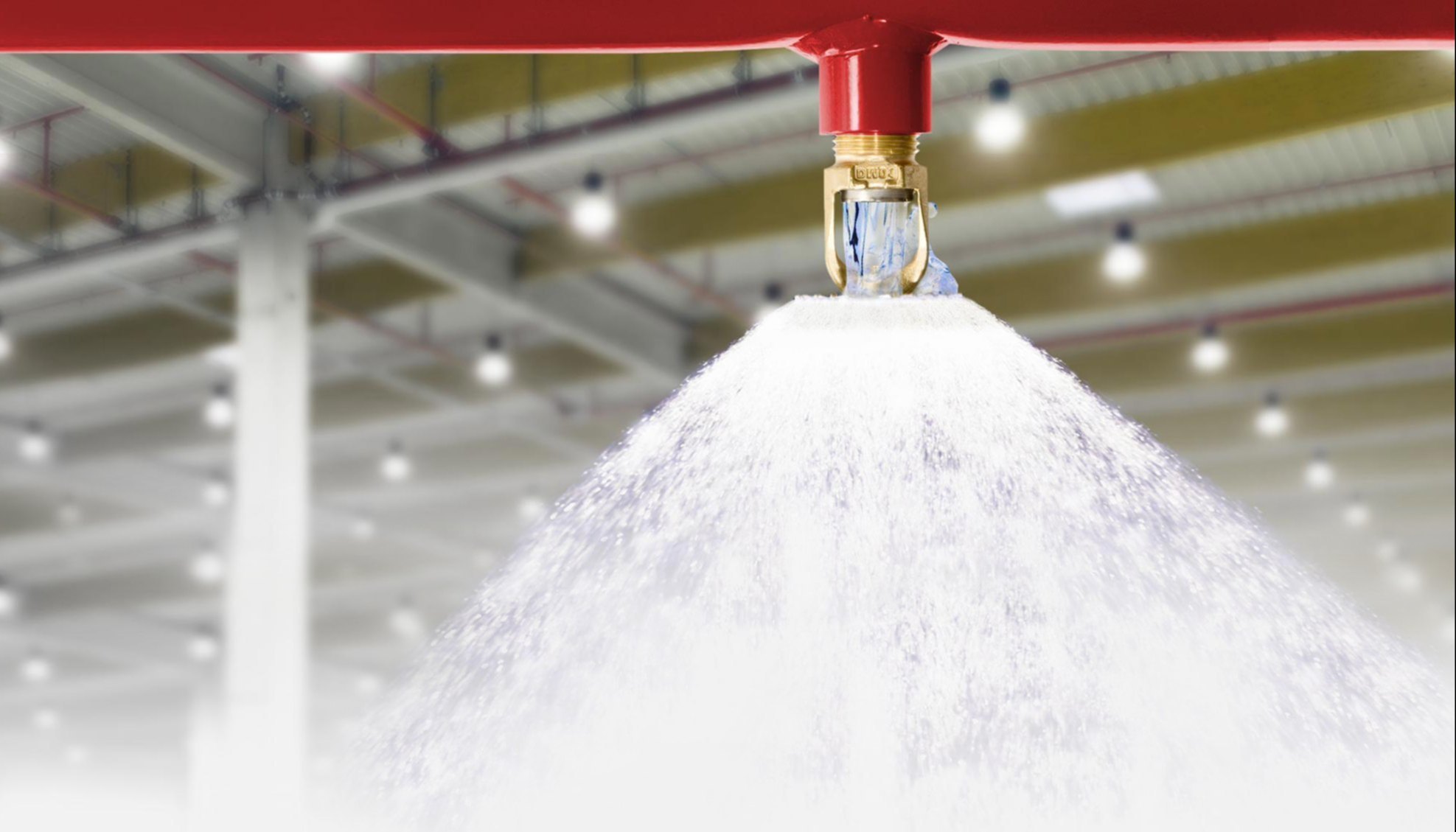 Active foam-water sprinkler discharging foam solution for rapid fire control in flammable liquid storage areas.