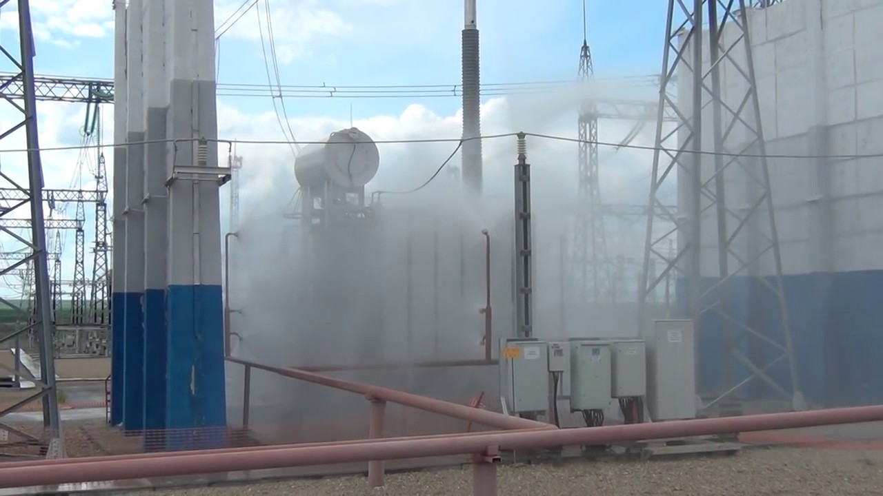 Deluge water spray fire suppression system activated to protect outdoor electrical transformer from fire hazards