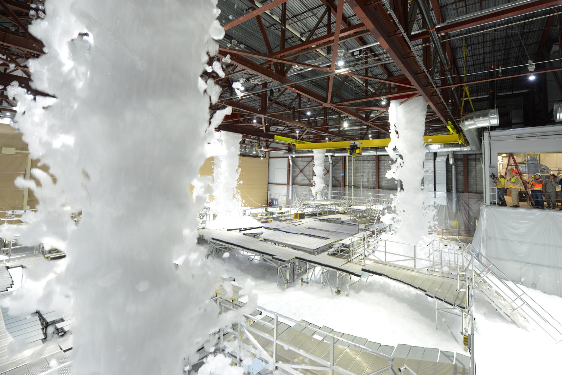 Active foam fire suppression system operating in a large factory