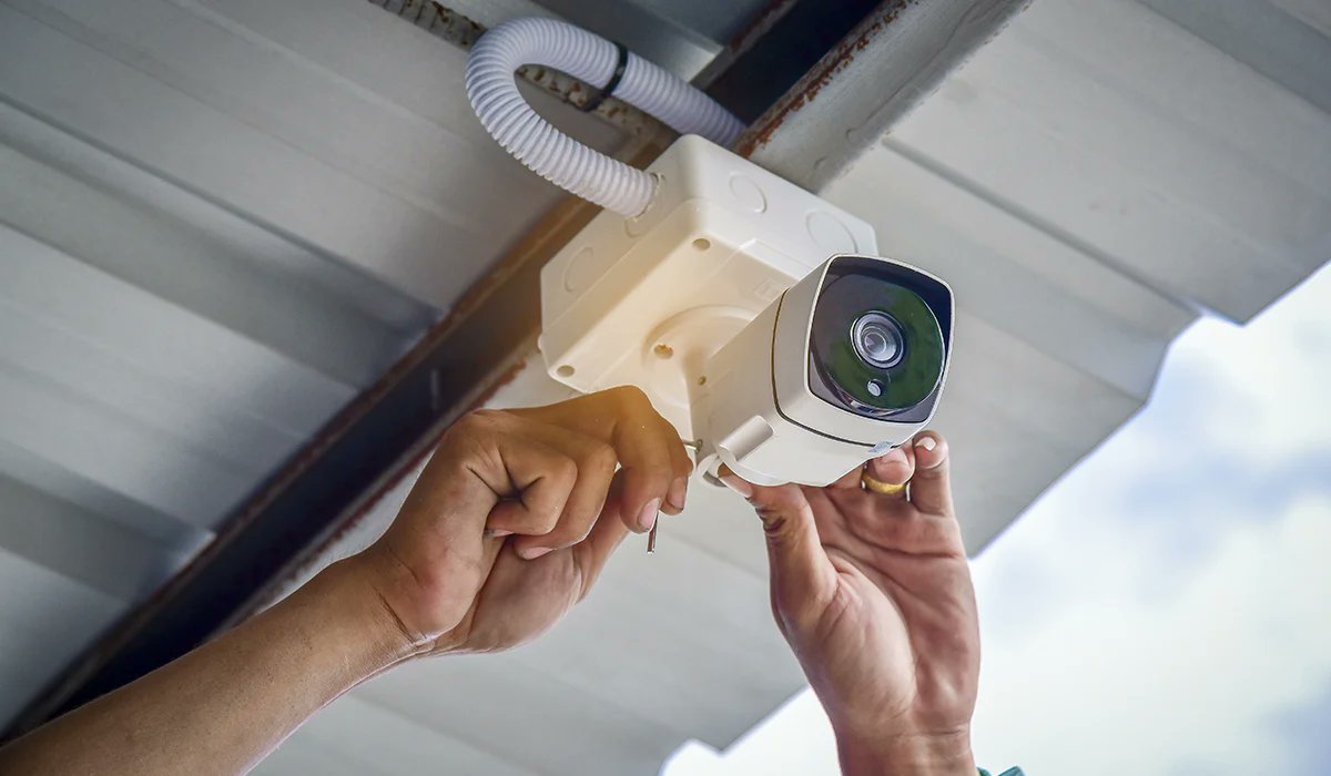 Installation of a surveillance bullet camera on a building ceiling for surveillance system setup